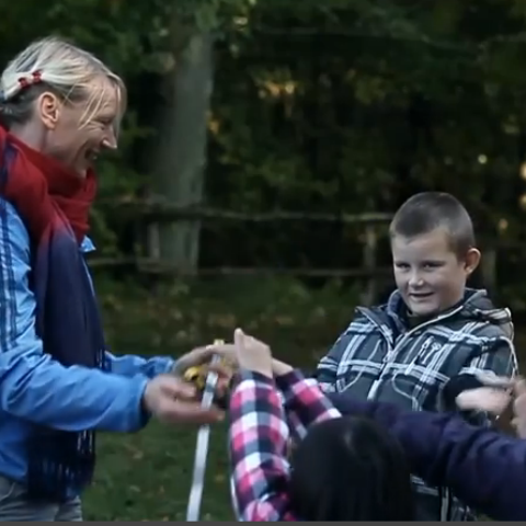 A teacher is teaching outside the classroom 